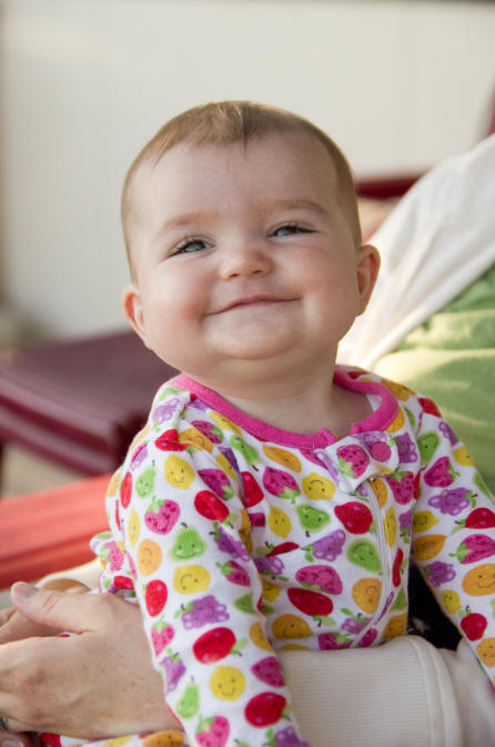 Image of Baby A with a big grin on her face by Elizabeth Powis Fulks.