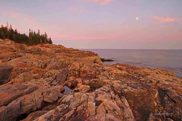 Photo guide to Acadia National Park: Rocky shoreline at sunrise with full moon in the distance by Juergen Roth.
